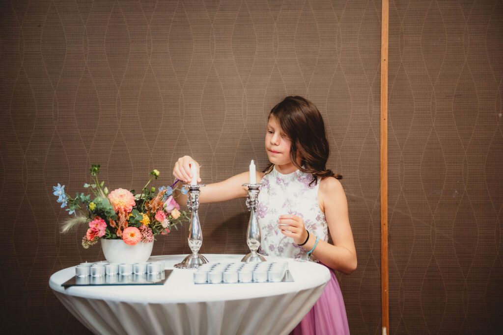 Candle lighting by bat mitzvah girl at ceremony