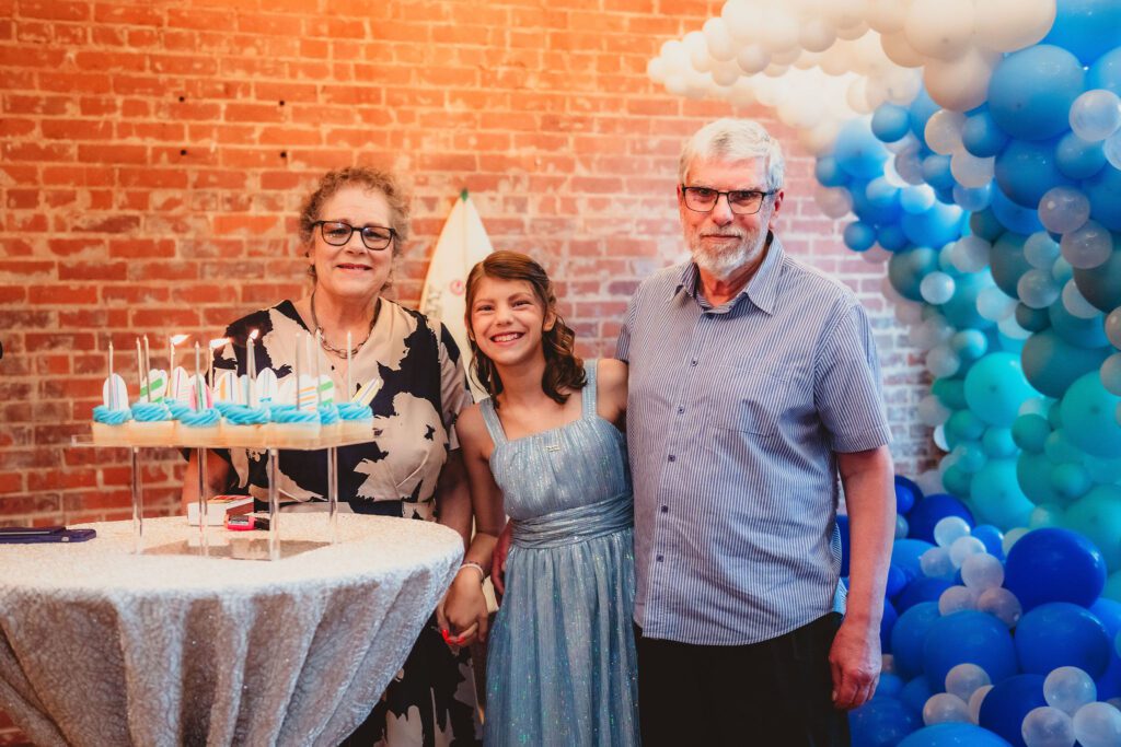 Bat Mitzvah Guest of Honor Doing candle lighting ceremony with grandparents